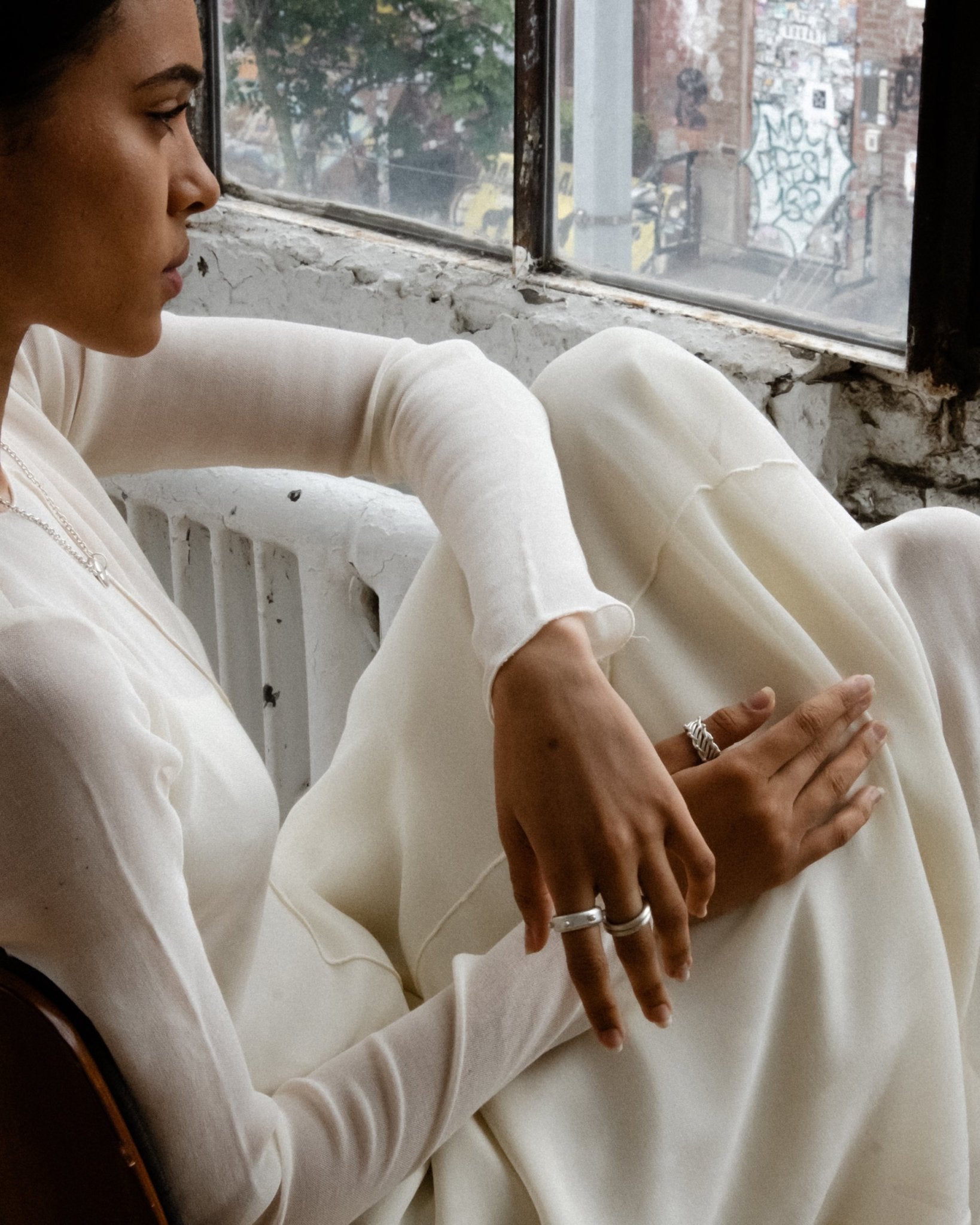 CKLASIC donut ring styled with other sculptural jewelry