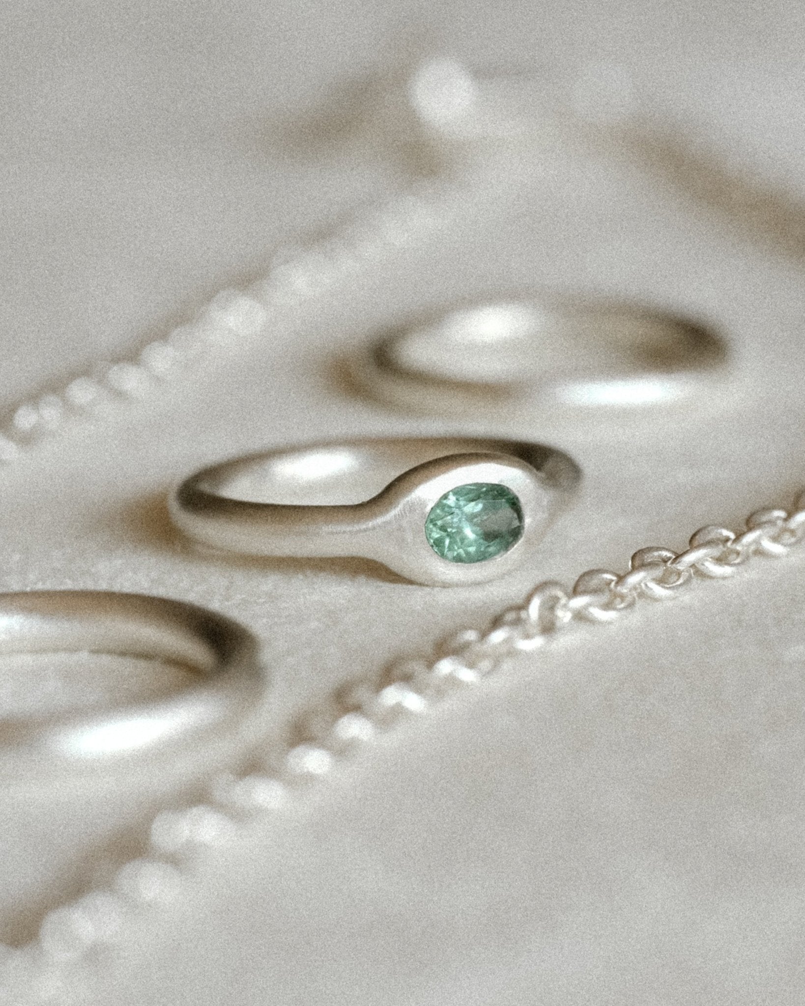 Minimalist silver gemstone ring with rounded band and mint tourmaline gemstone