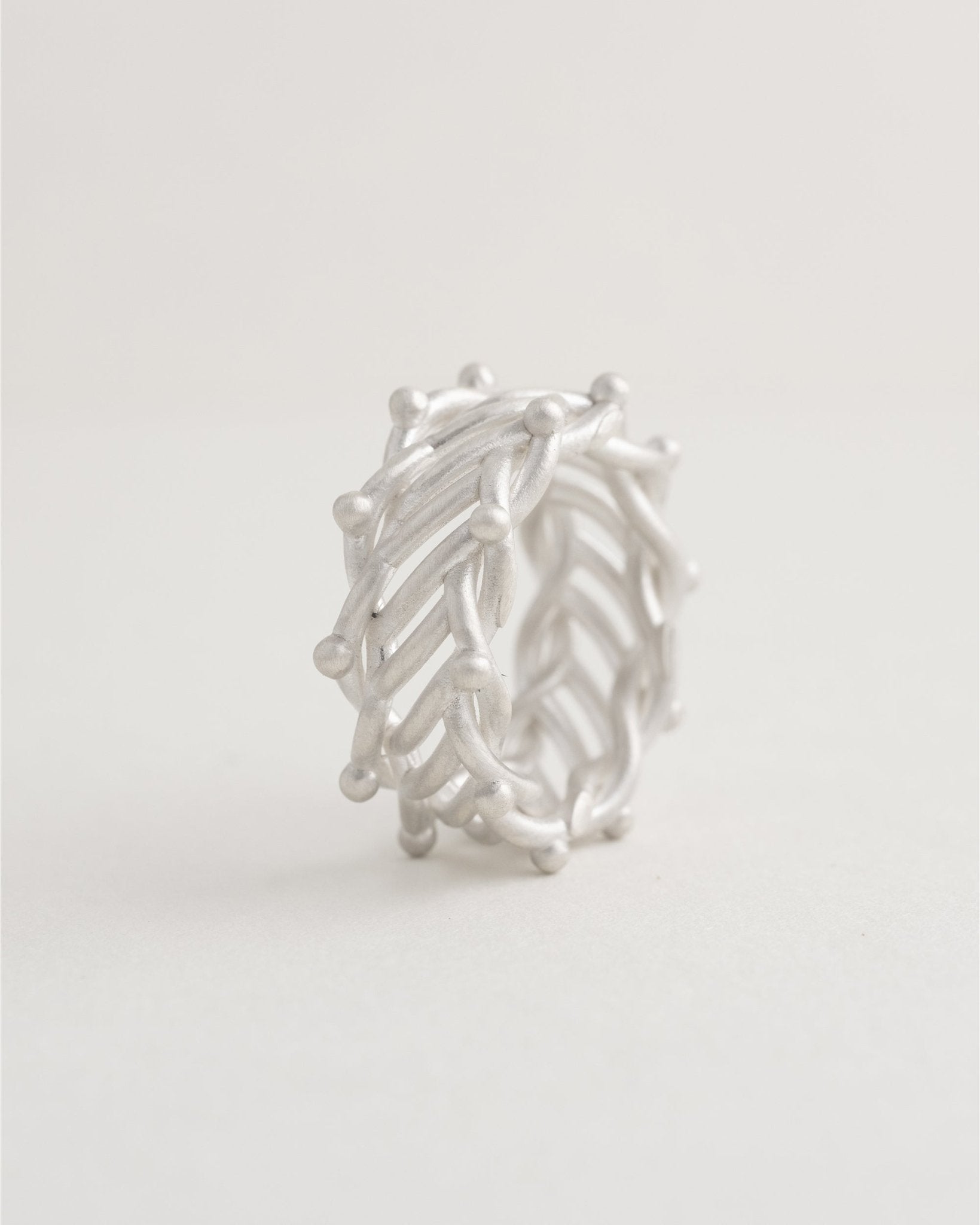 Openwork silver ring with dotted border accents