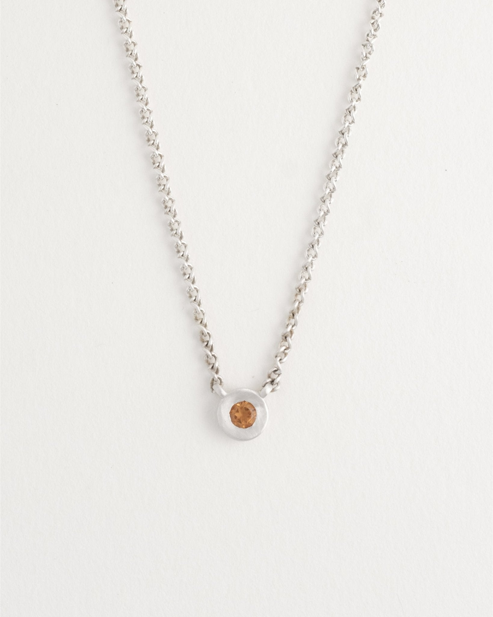 Delicate sterling silver necklace styled on model’s neck