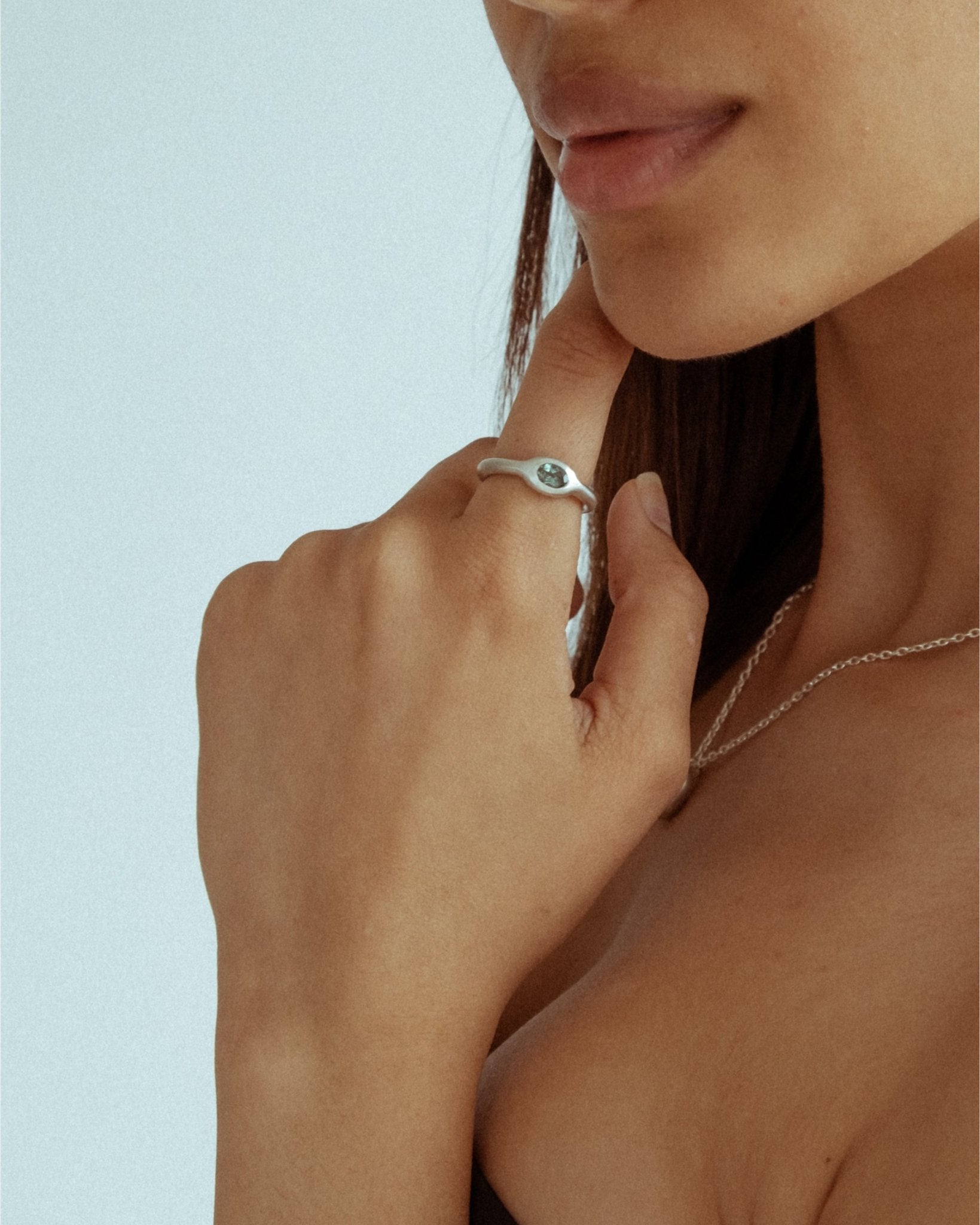 Sterling silver sculptural jewelry styled on hand