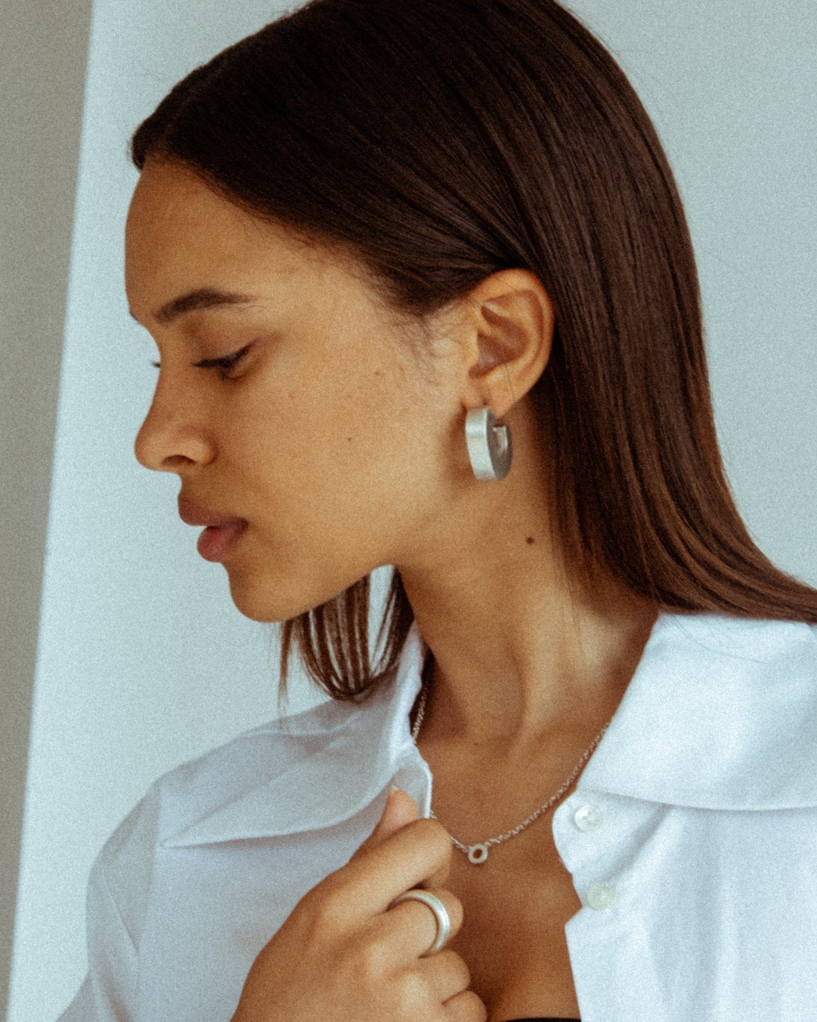 CKLASIC big Rhea earrings photographed on model’s ear
