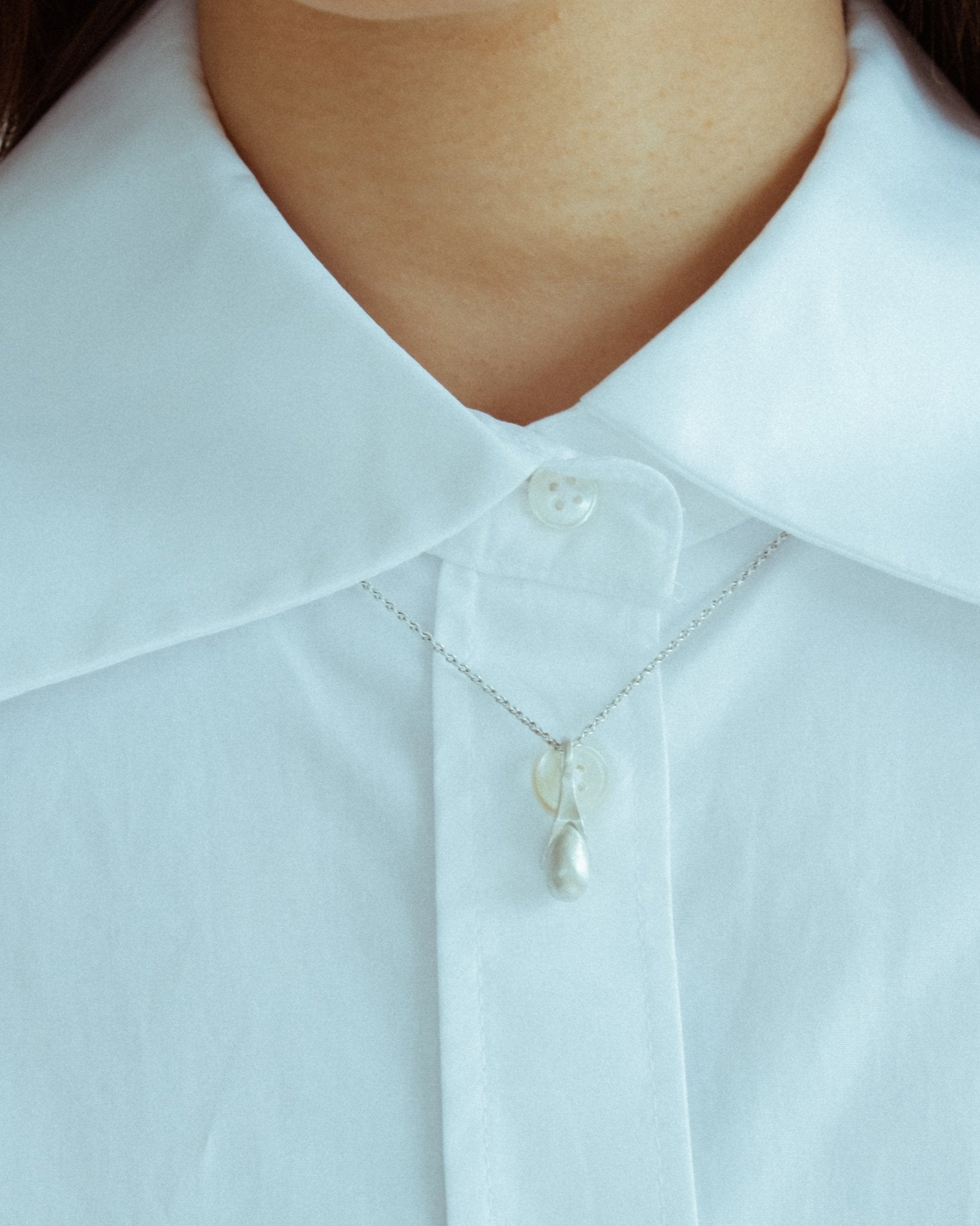 Solid silver pendant shaped like a round stone in bead cap form