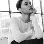 Sculptural silver pendant necklace styled on model’s neck