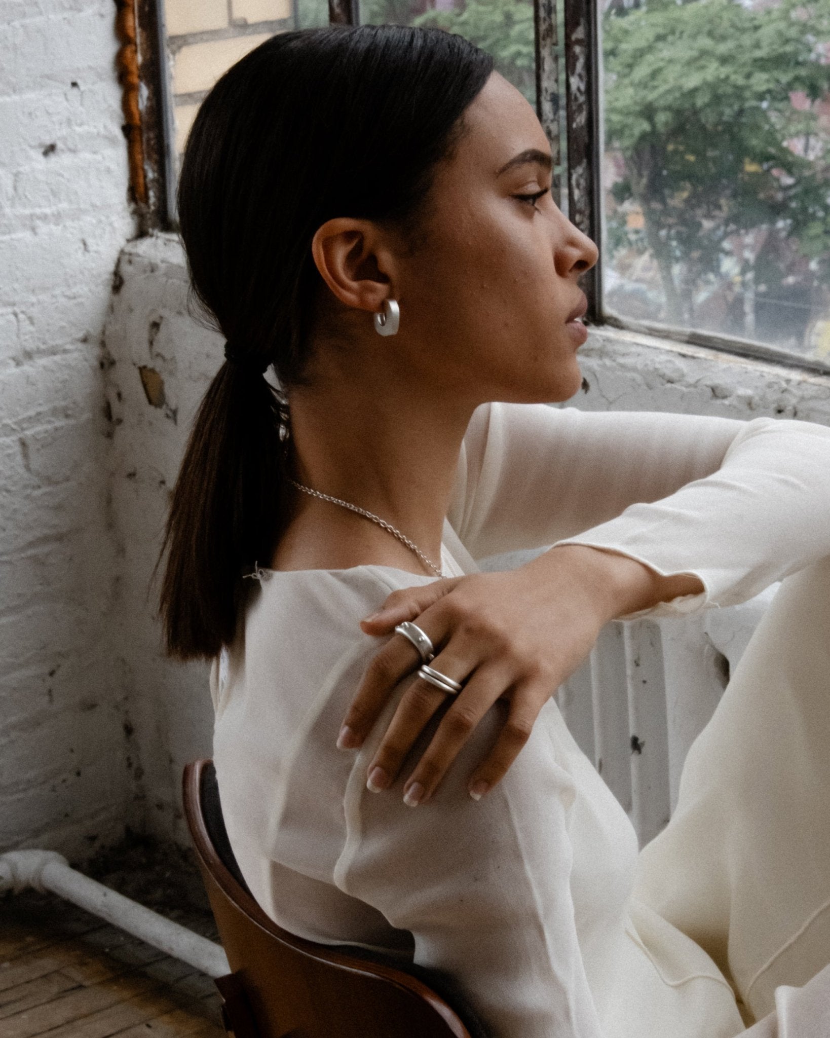 Lightweight silver hoops worn on model’s ear