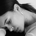 Sculptural silver earrings styled on model’s ear