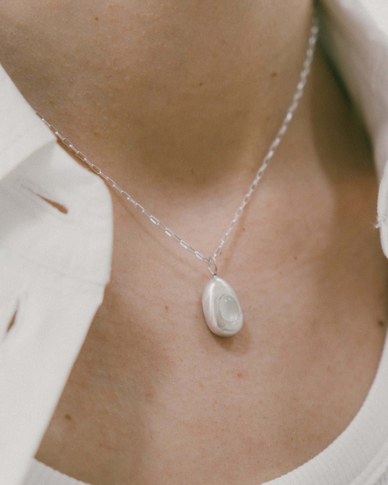 CKLASIC Egg Drop necklace styled on model