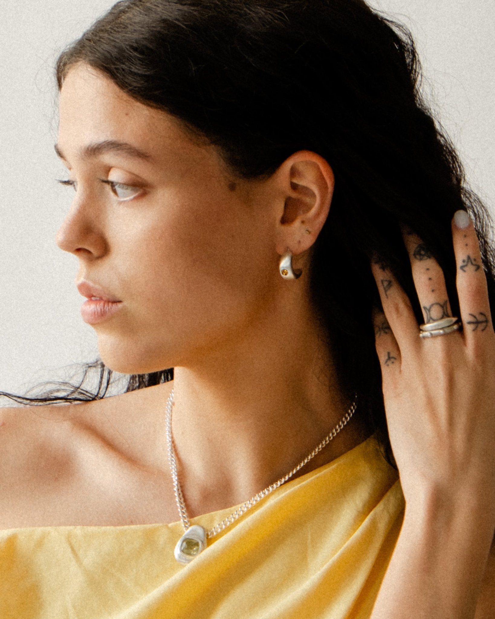 CKLASIC Elise earrings featuring sapphire center detail