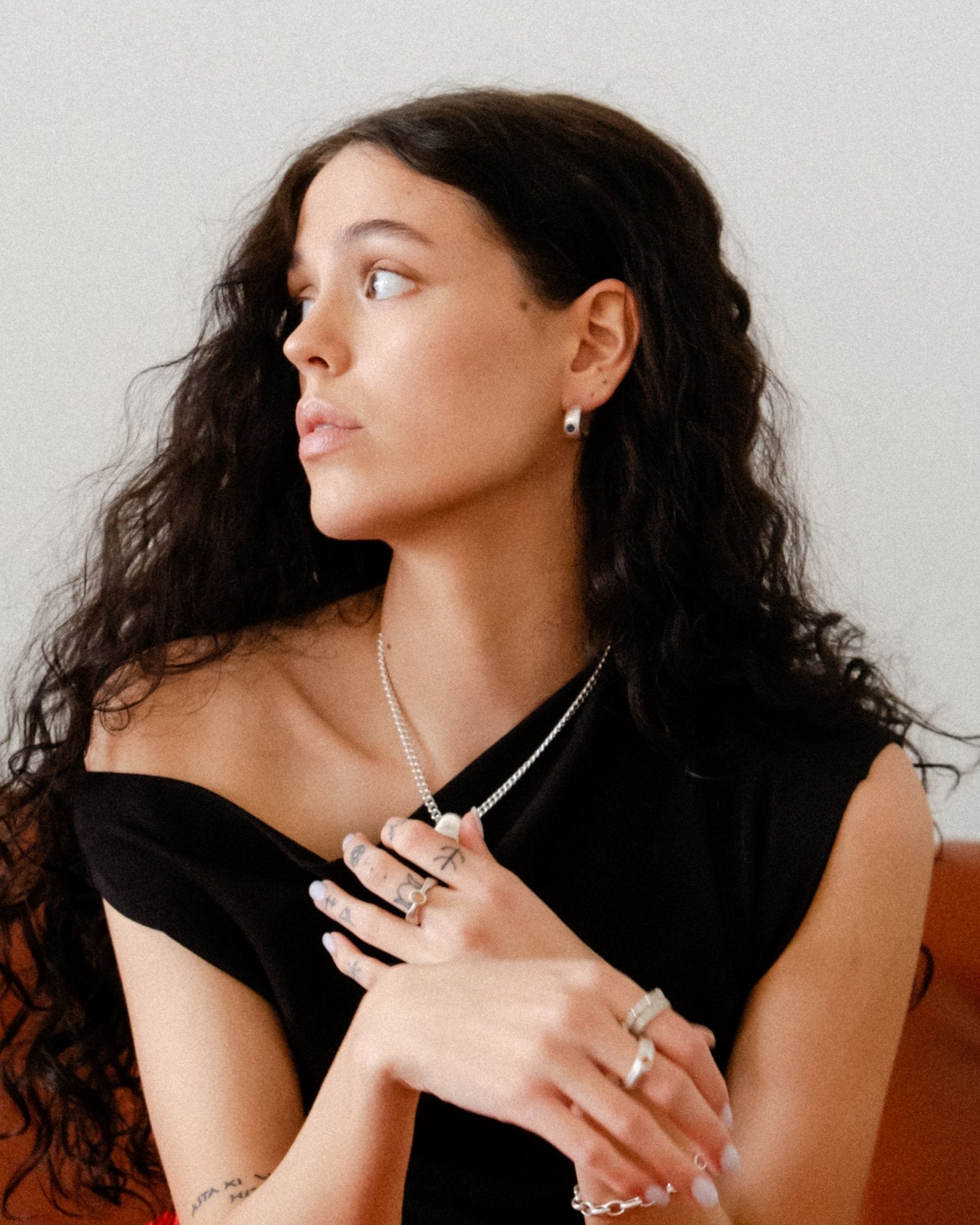 Sterling silver gemstone earrings photographed on model’s ear