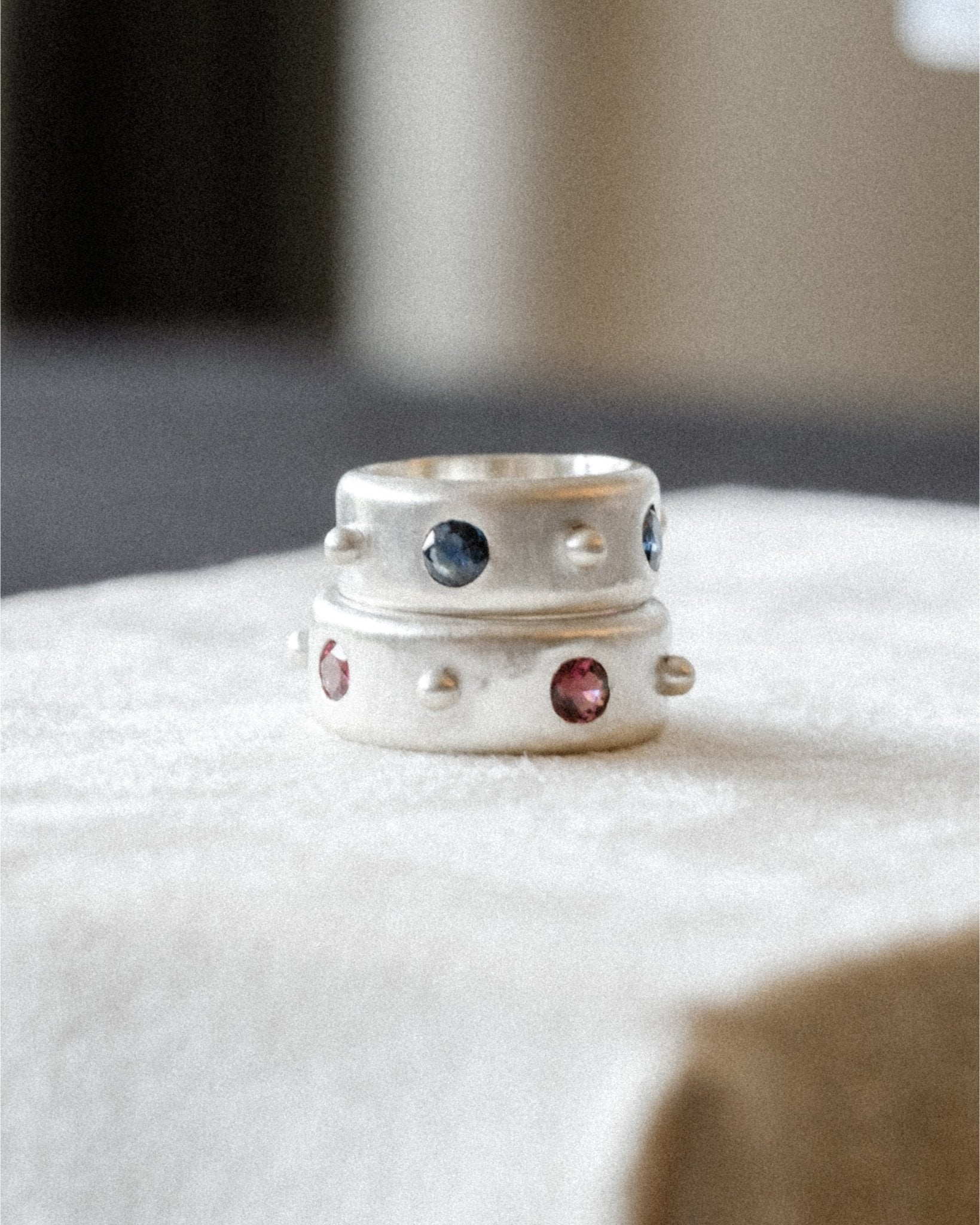 Wide 4‑stone sterling silver band featuring polished dot spacing