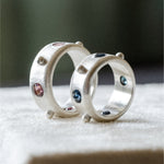 Sterling silver ring set with blue sapphires spaced by silver dots