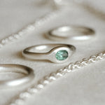 Minimalist silver gemstone ring with rounded band and mint tourmaline gemstone