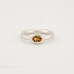 Silver donut band ring with nutmeg zircon stone