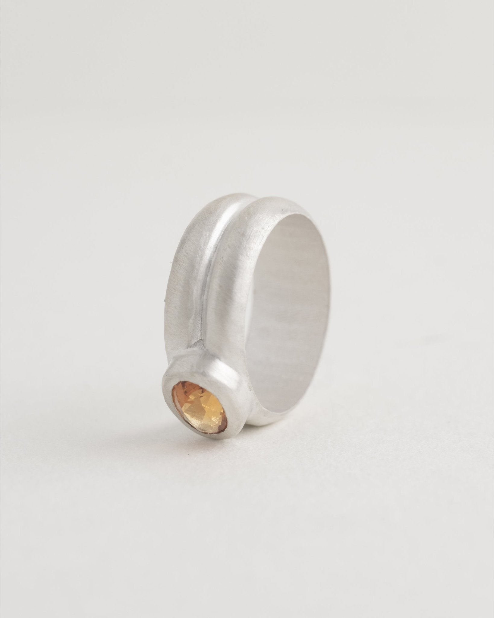 Sterling silver band ring with modern bezel setting