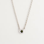 Minimalist silver pendant necklace featuring sapphire