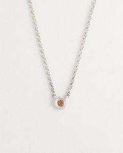 Delicate sterling silver necklace styled on model’s neck