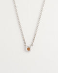 Delicate sterling silver necklace styled on model’s neck