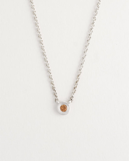 Delicate sterling silver necklace styled on model’s neck