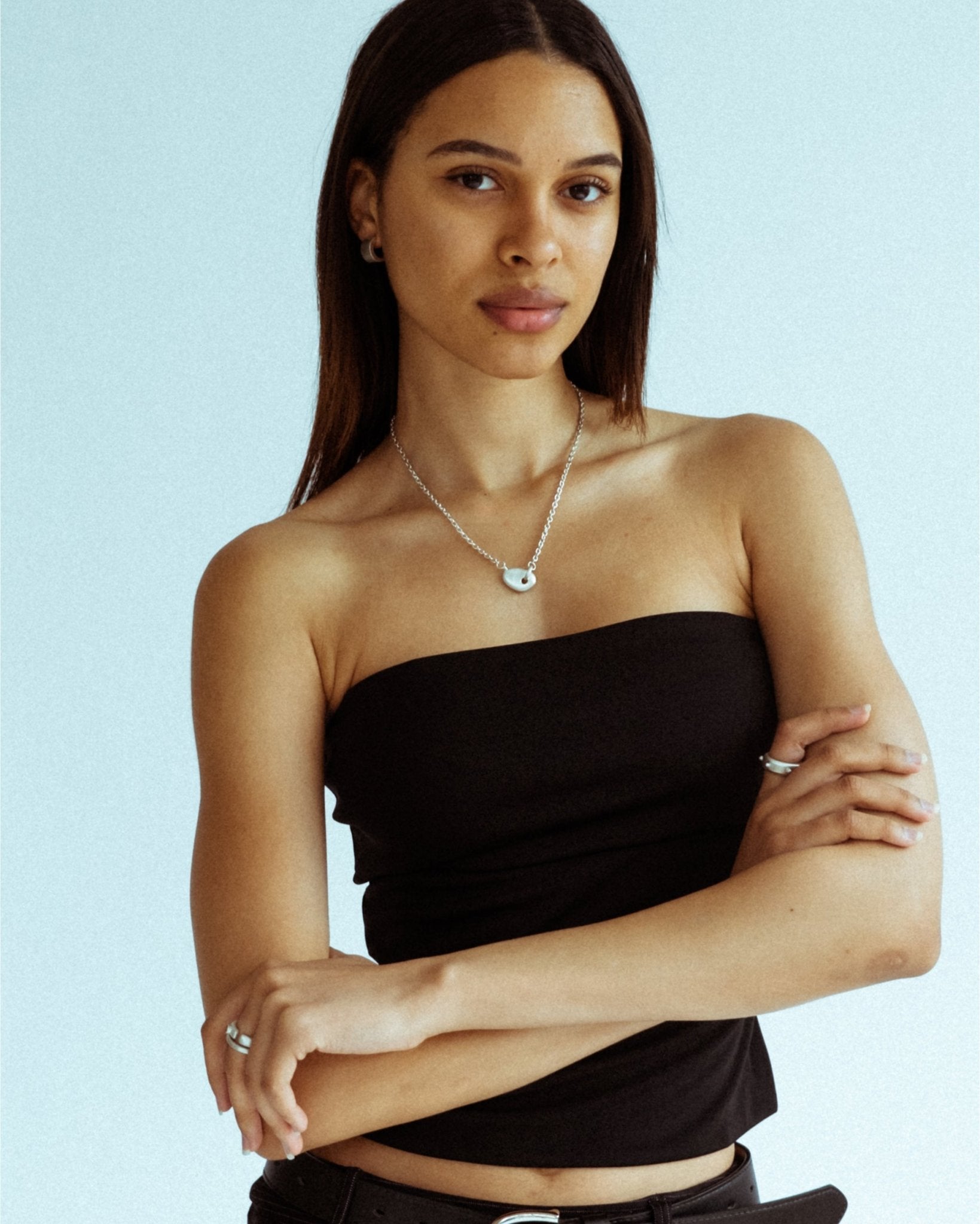 Solid sterling silver half hoops styled on model’s ear