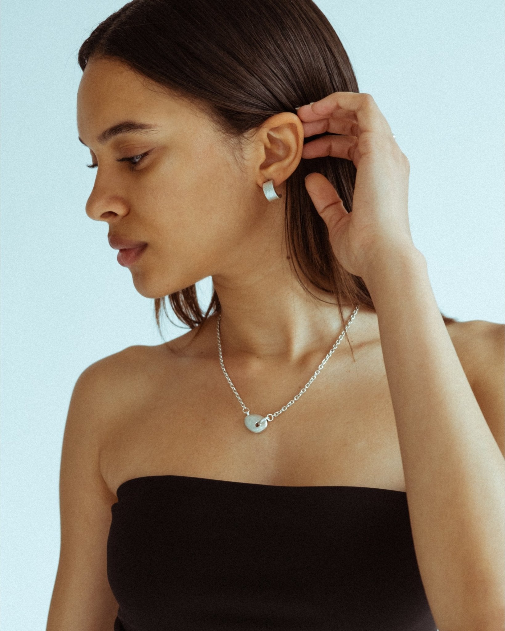 CKLASIC Arc earrings with streamlined sculptural design