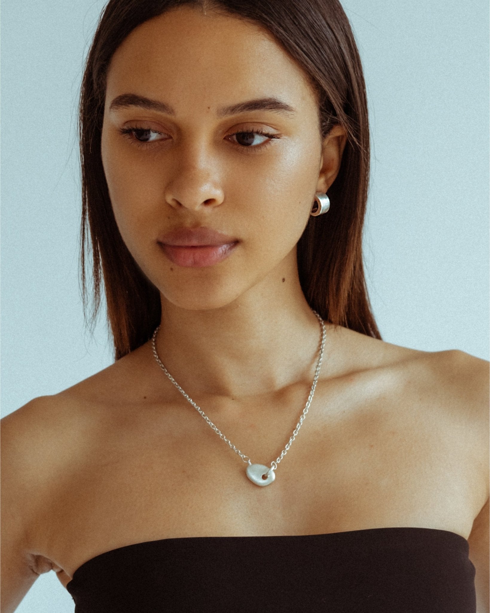 Sculptural silver half hoop earrings designed for daily wear