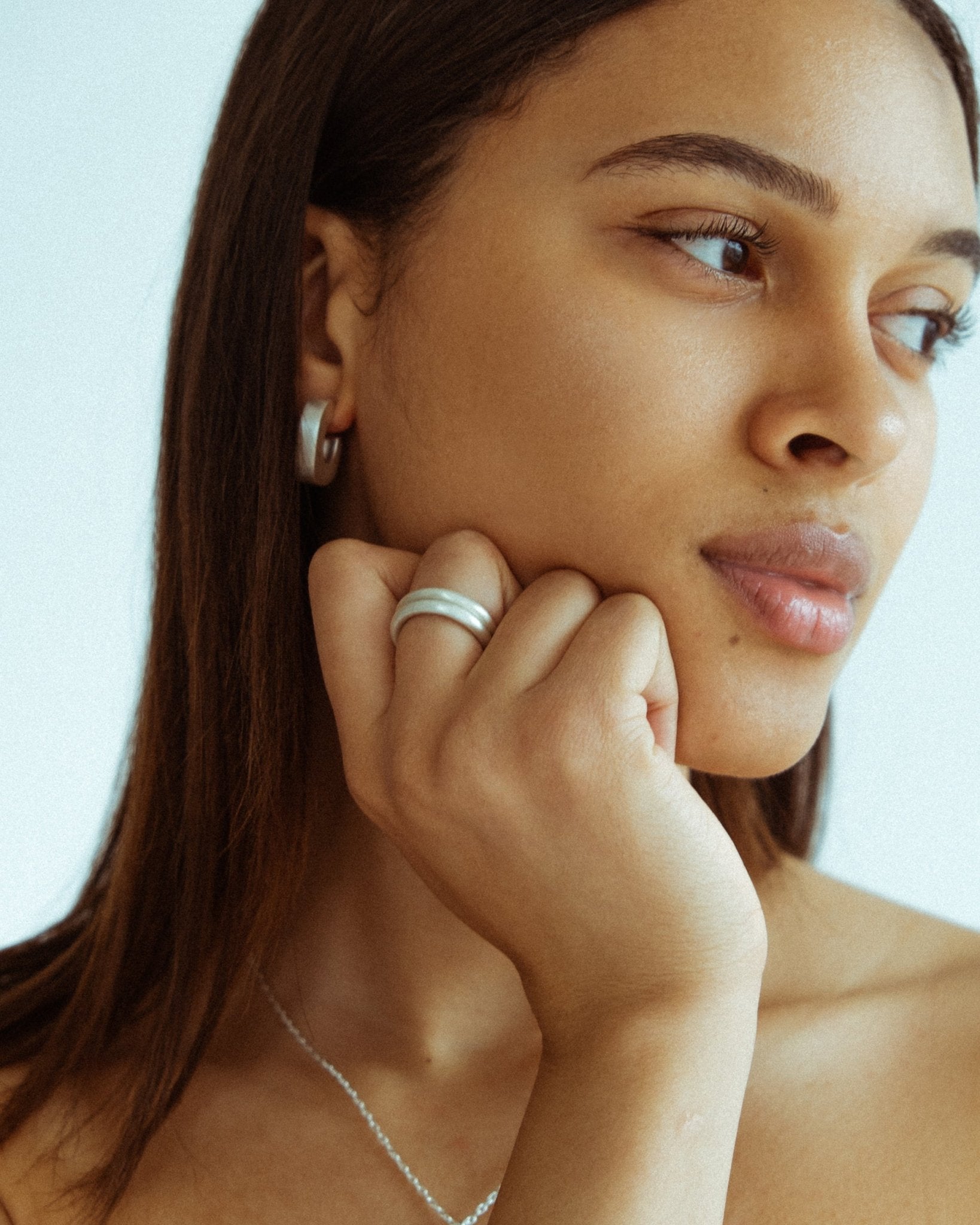 Pair of silver donut rings worn together on hand