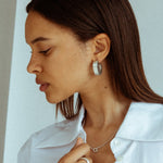 CKLASIC big Rhea earrings photographed on model’s ear