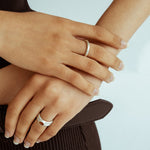 Sculptural silver donut ring photographed on hand