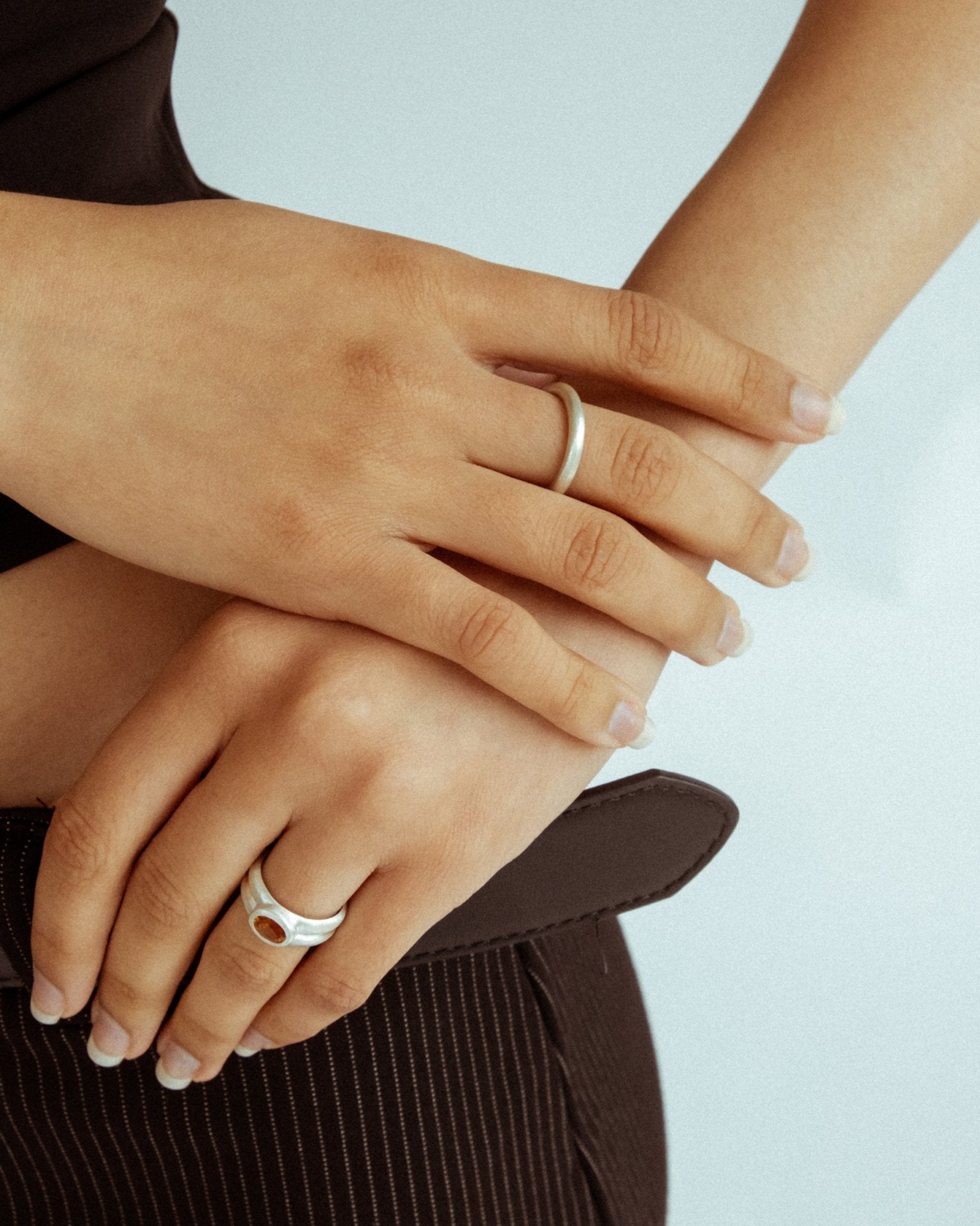 Sculptural silver donut ring photographed on hand